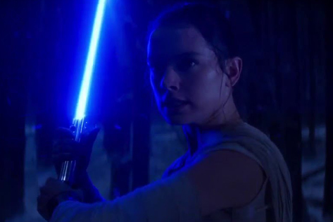 Rey with lightsaber.